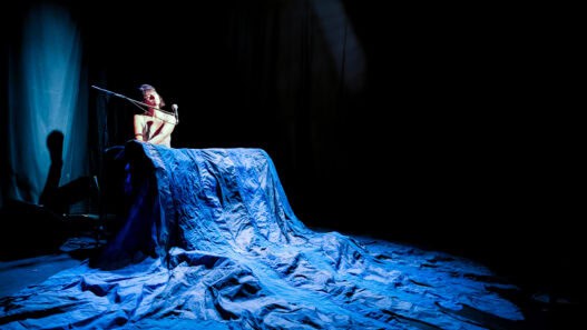 Performance artistique représentant la liberté et l'expression corporelle, avec une figure nue sur s.